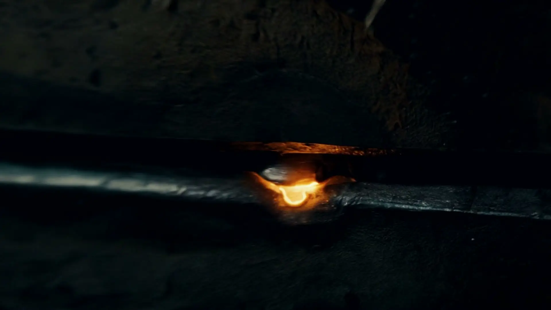 A welder's molten seam joining steel, where the craft began